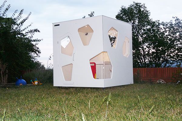 Wooden wendy house over grass